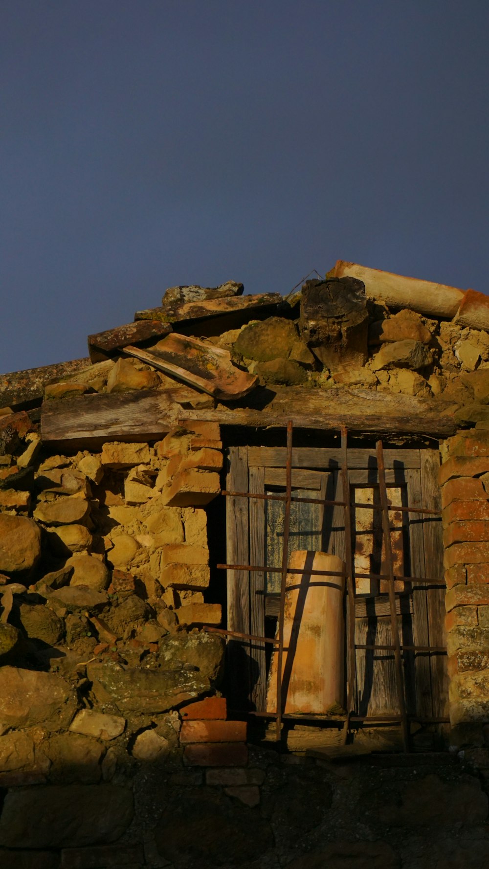 a window on a stone building with a ladder