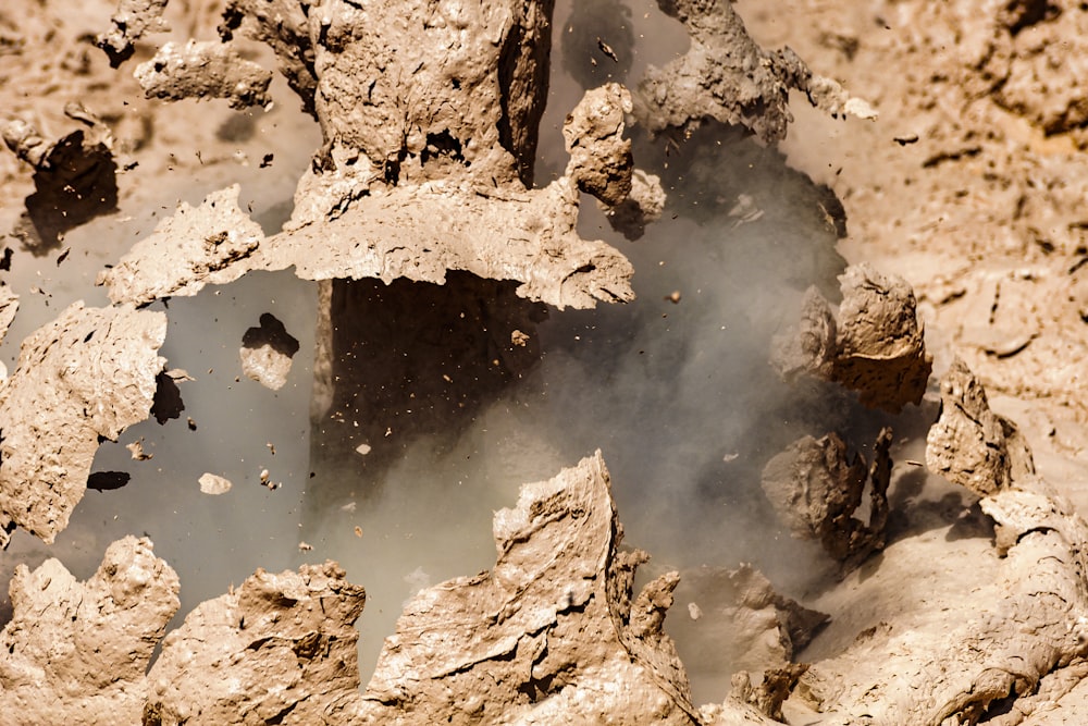 a close up of a rock formation with steam coming out of it