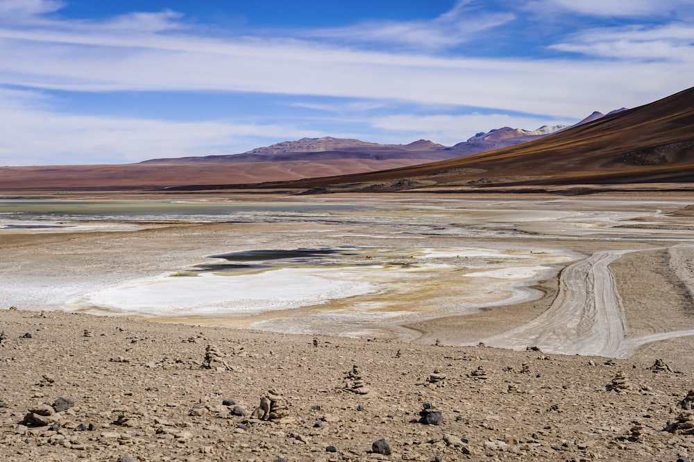 a barren landscape with mountains in the background