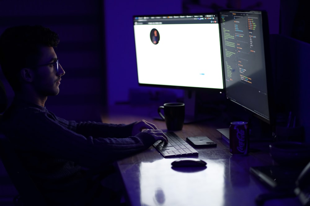 a man sitting at a desk in front of a computer