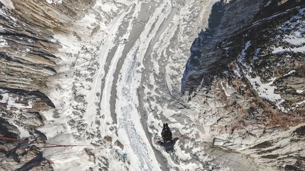 a man walking up a snow covered mountain side