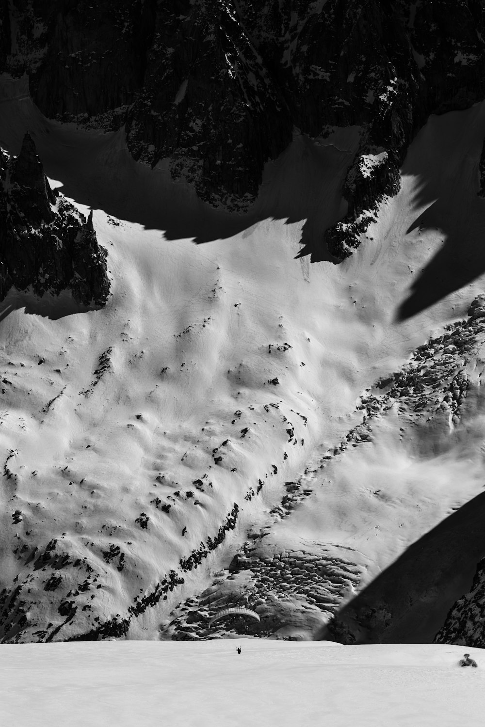 a man riding skis down the side of a snow covered slope