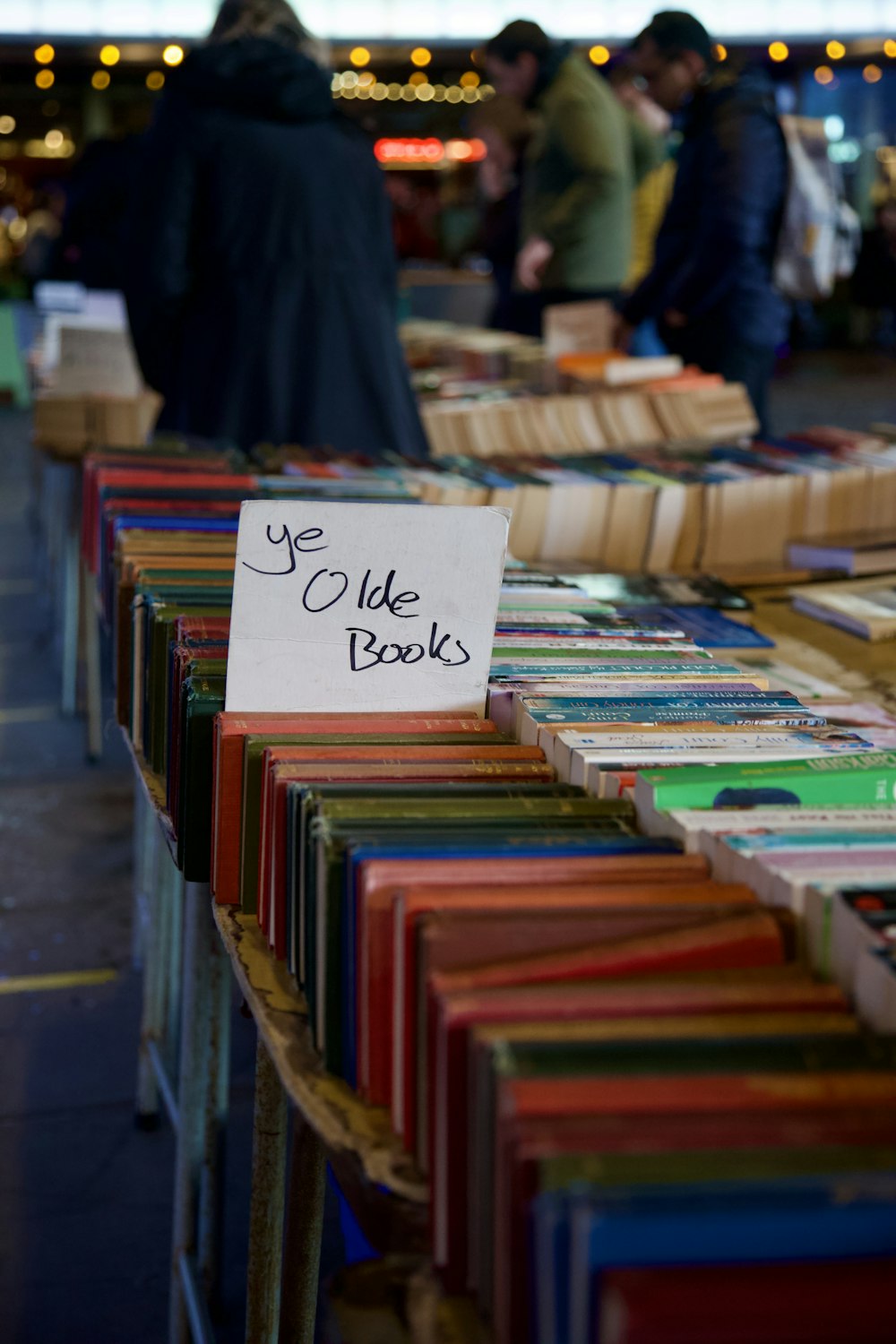 a table topped with lots of books under a tent