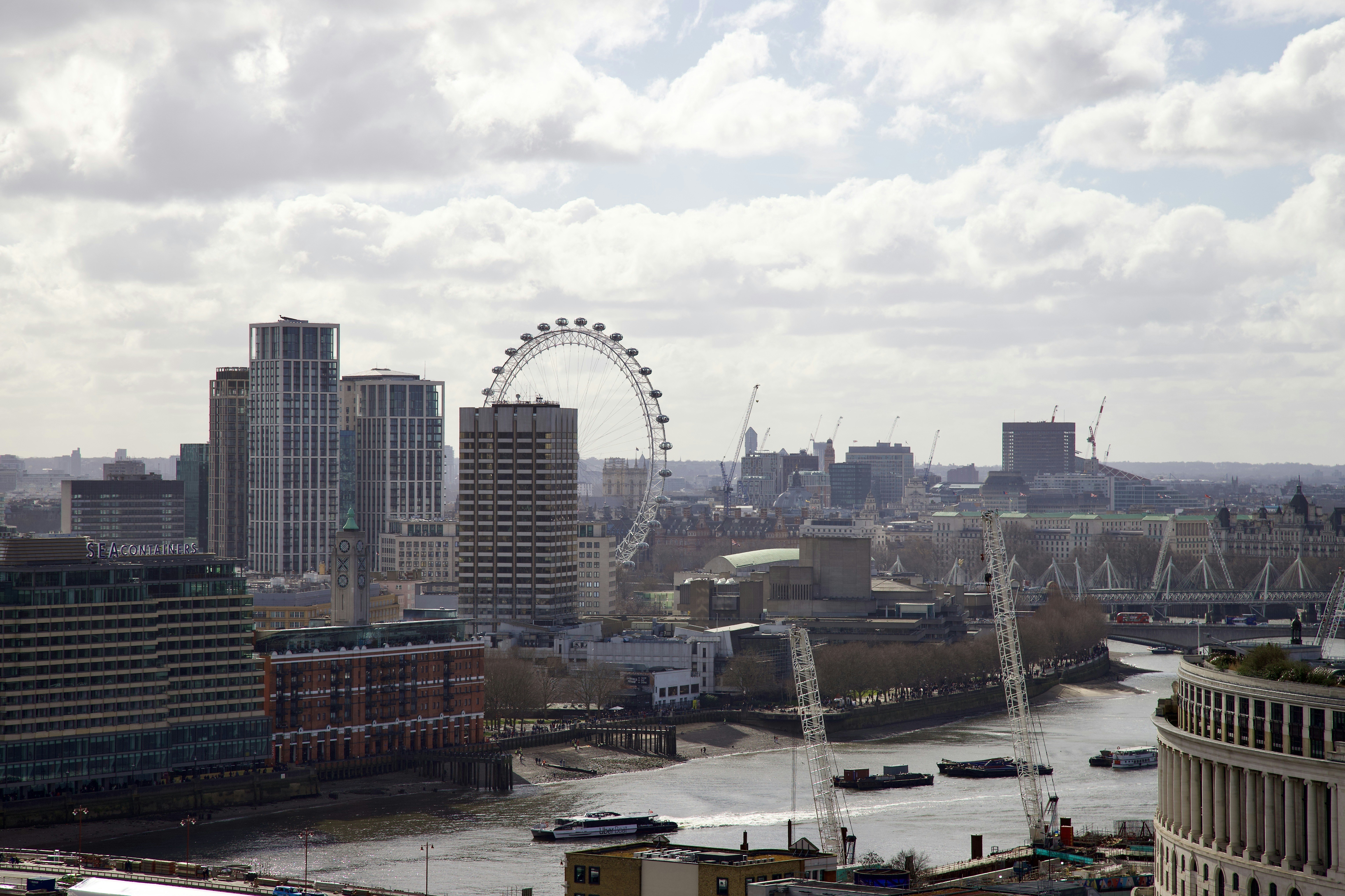 a view of a city with a ferris wheel in the distance