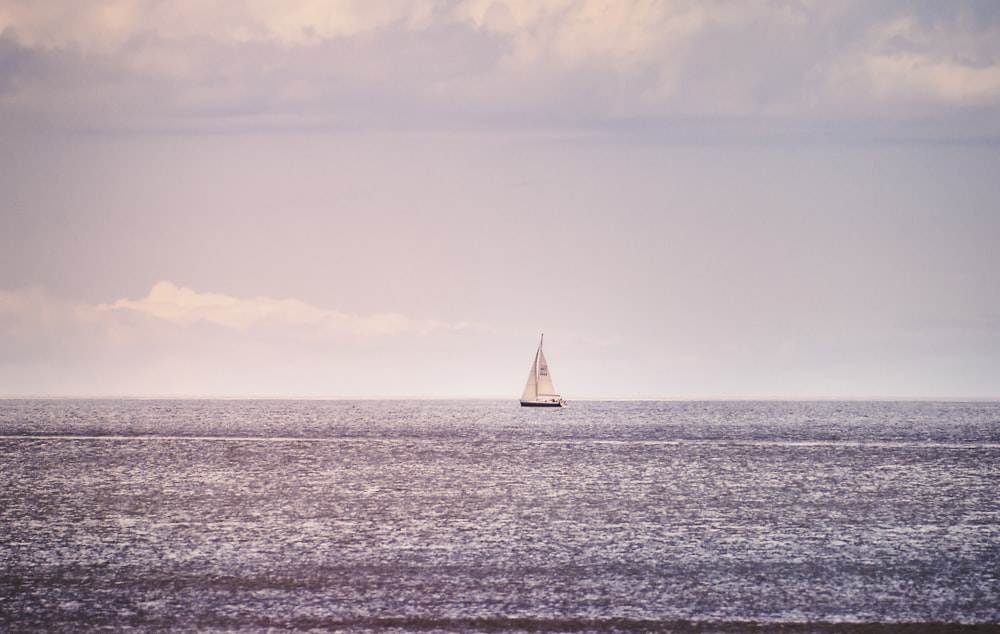 a sailboat in the middle of the ocean