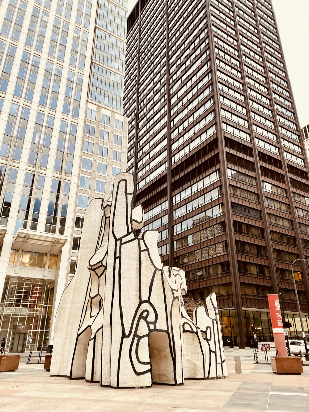 a tall building with a sculpture in front of it