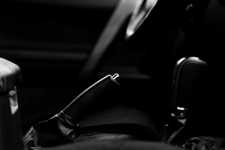 Close-up of hands comparing car brochures with warm colors in the background.