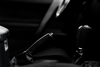 Close-up of hands comparing car brochures with warm colors in the background.