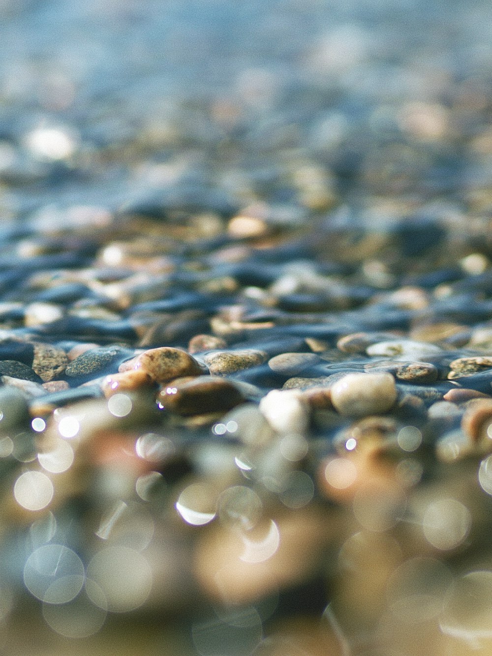 a close up of rocks and water on a beach