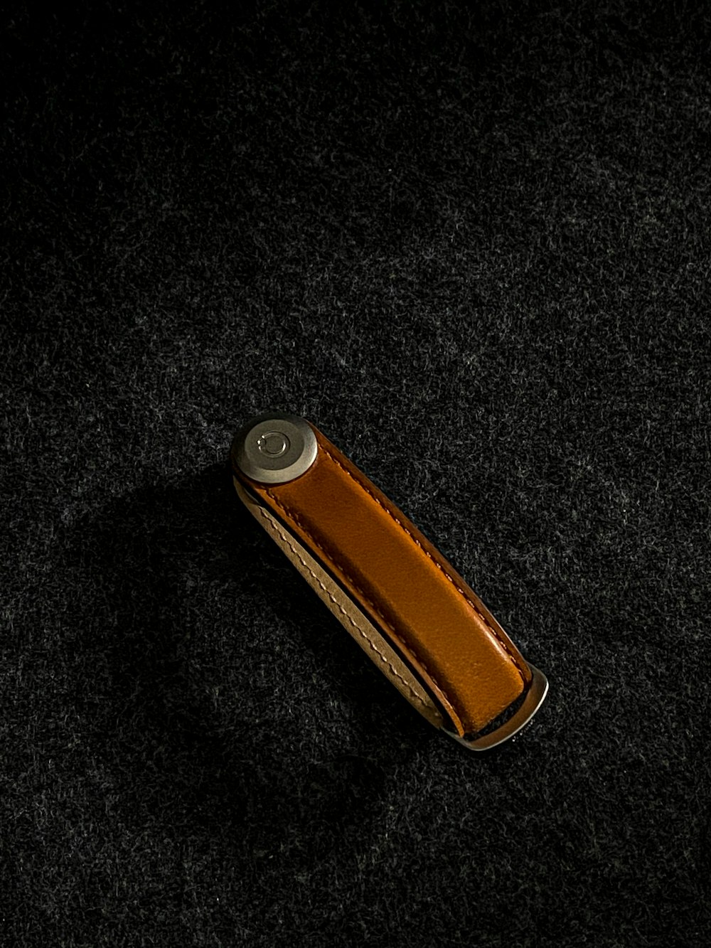 a lighter is laying on a black surface