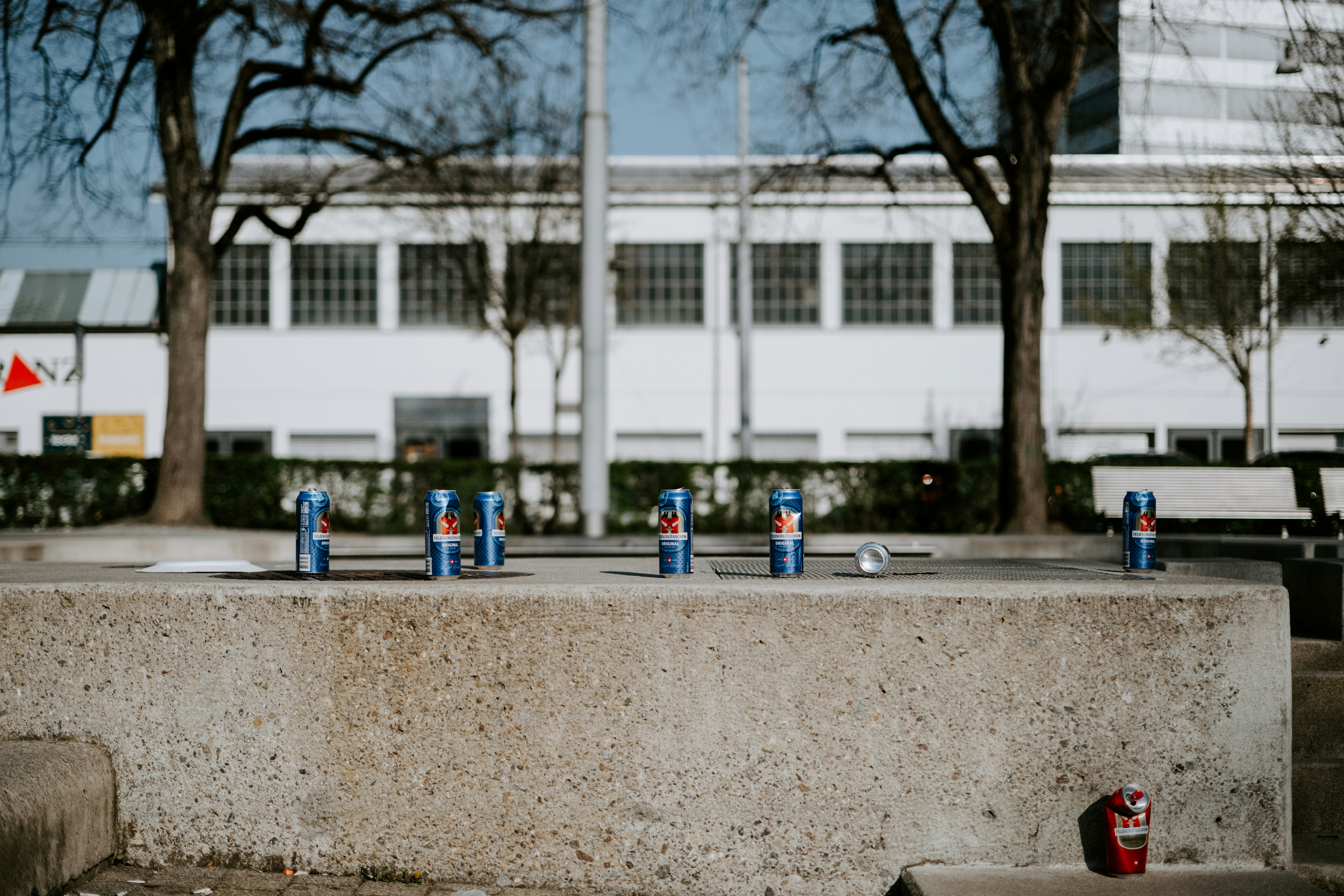 a group of blue fire hydrants sitting on top of a cement wall