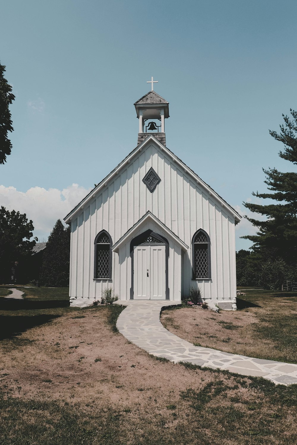 a small white church with a clock tower