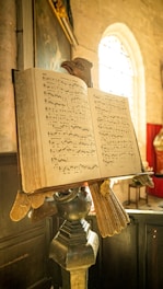 an open book sitting on top of a statue