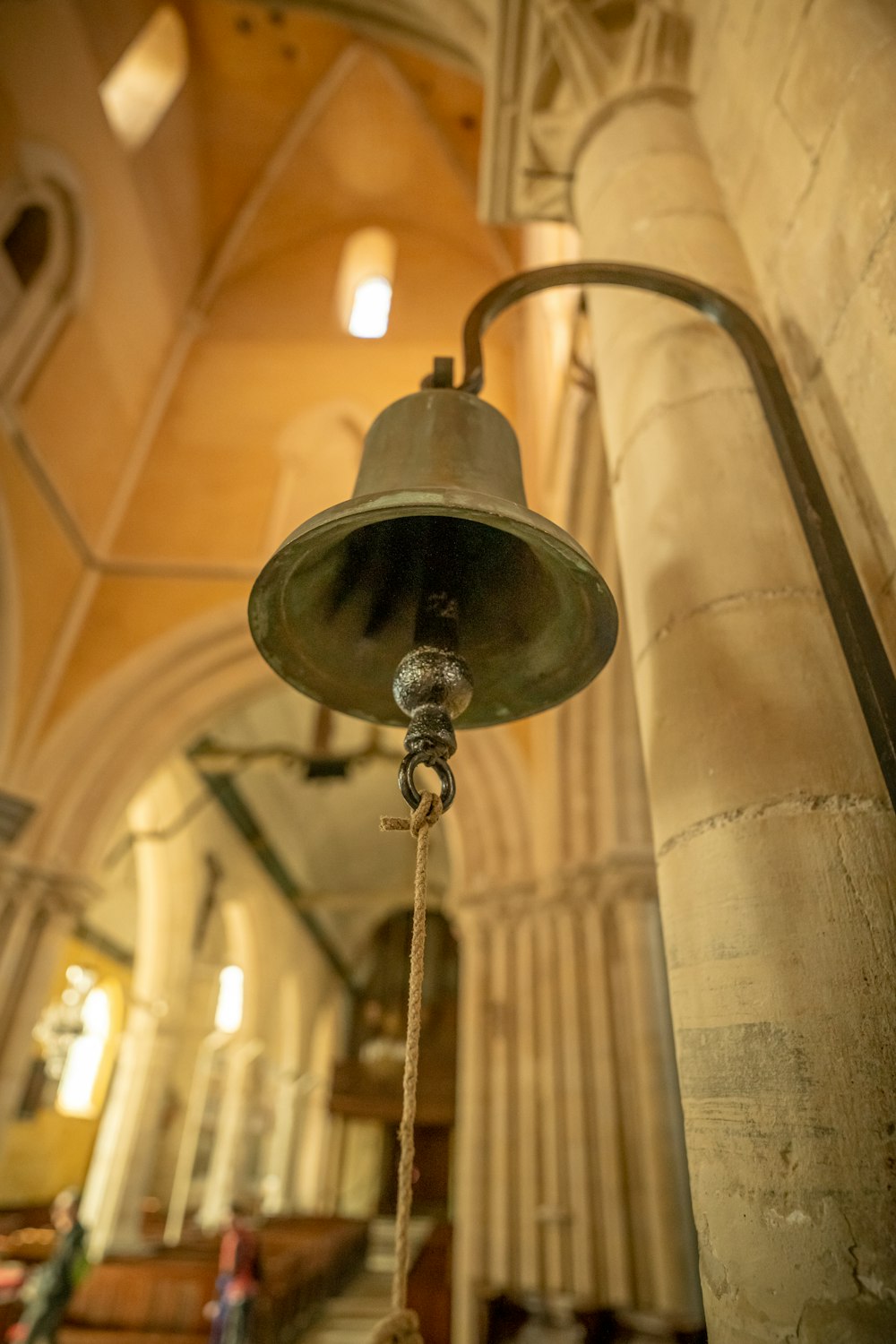 a bell hanging from the ceiling of a church