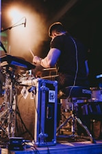 a man is playing drums on a stage