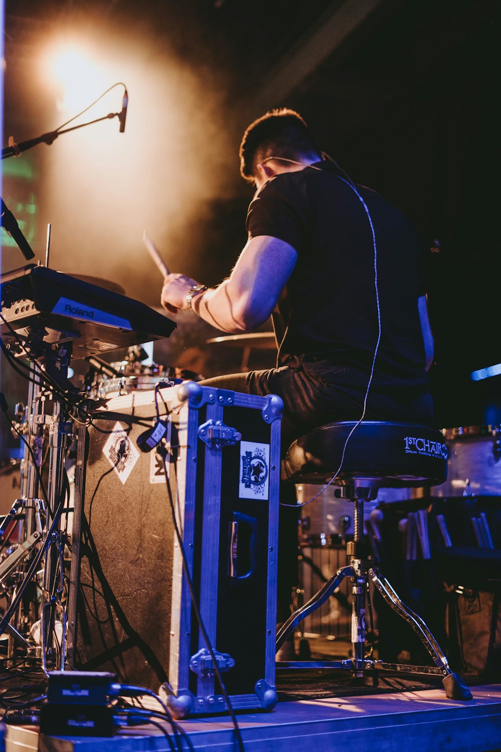 a man is playing drums on a stage