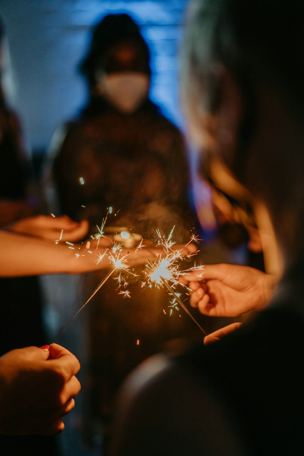 a group of people holding sparklers in their hands