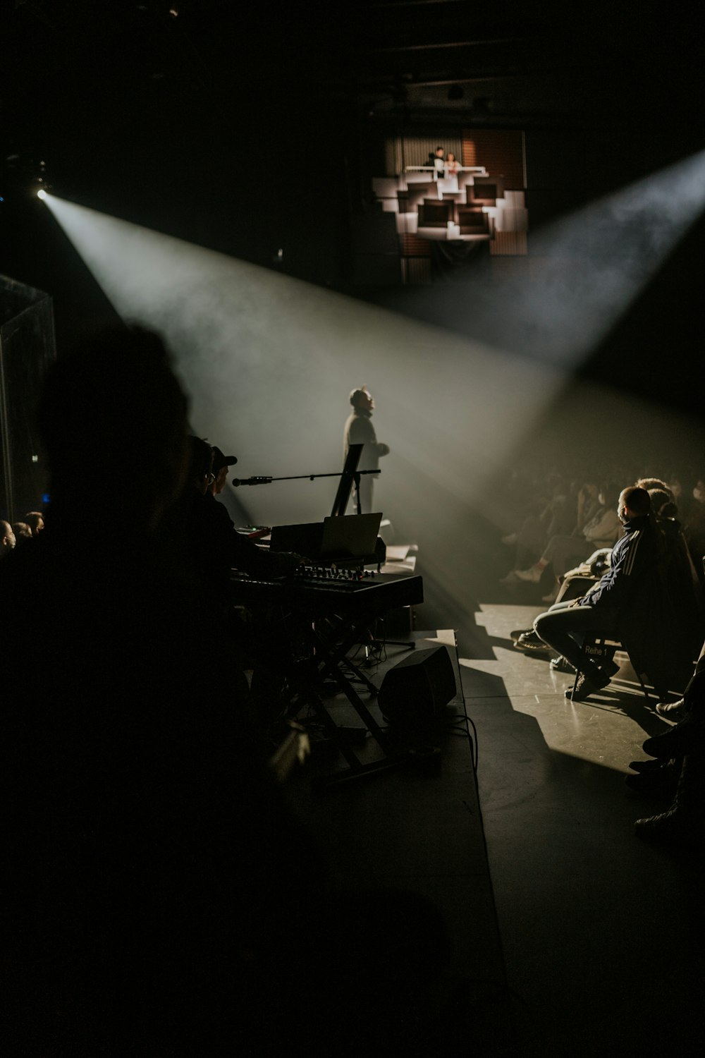 a group of people sitting in a dark room