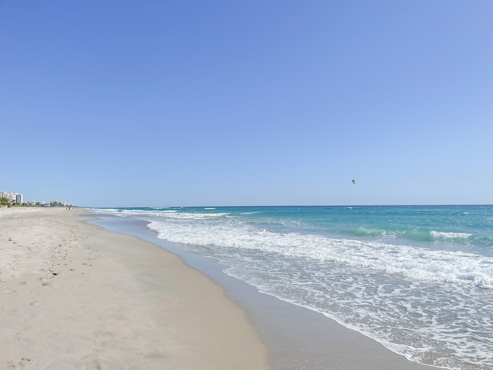 a view of a beach from the shore of the ocean