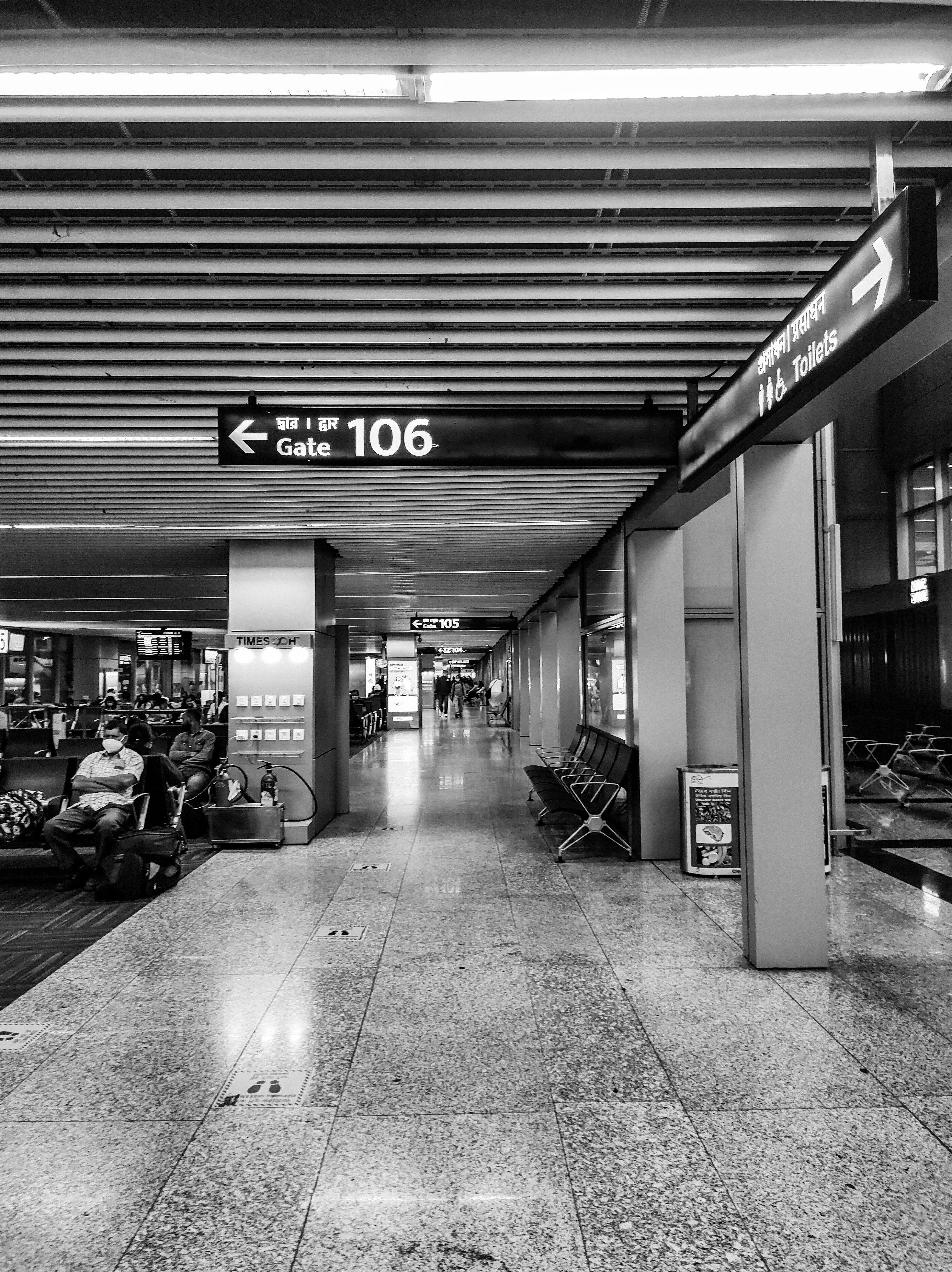 a black and white photo of an airport lobby