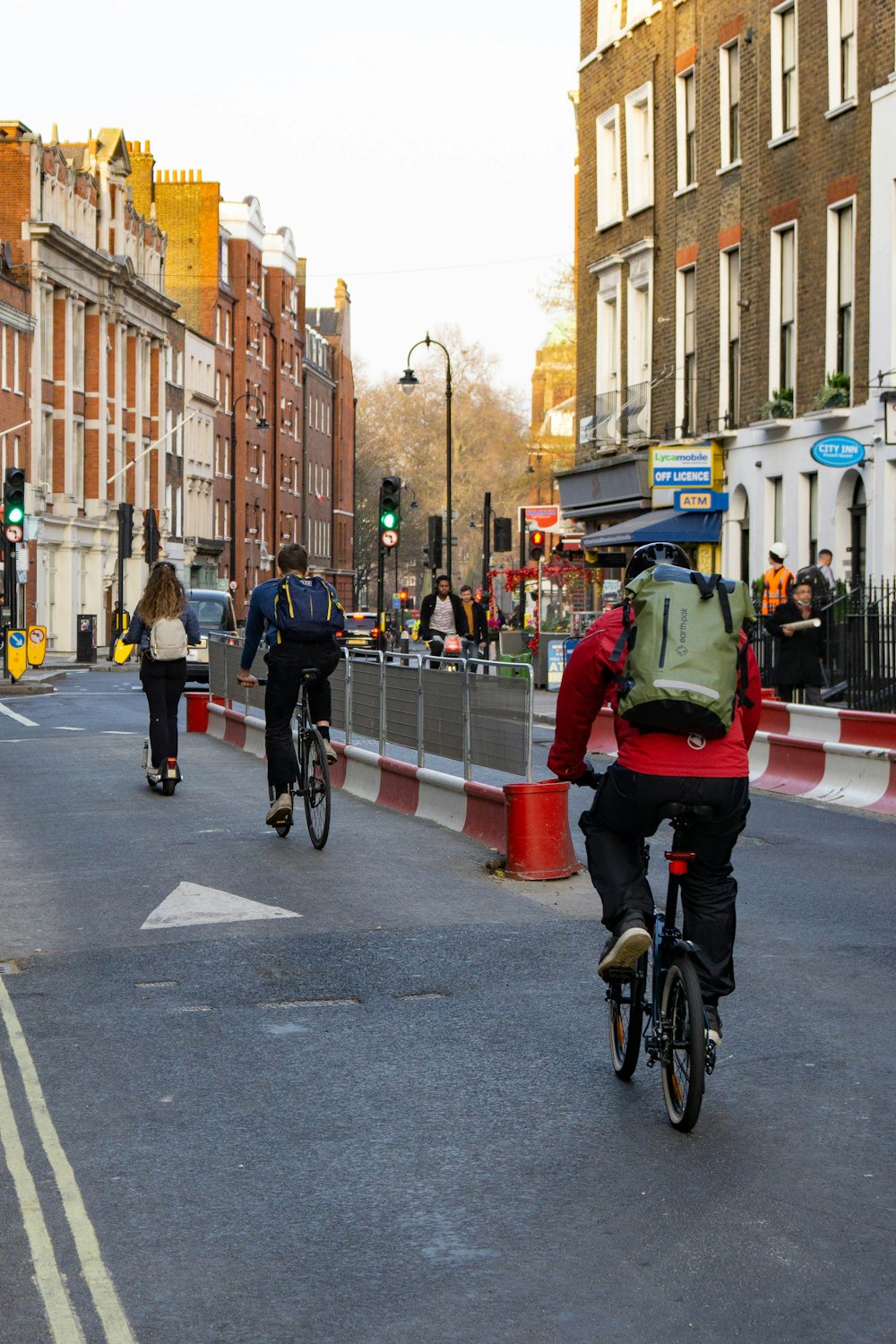 a group of people riding bikes down a street