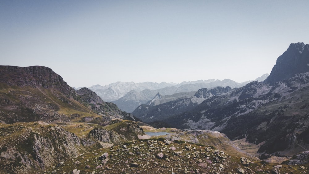 a view of a mountain range from the top of a hill