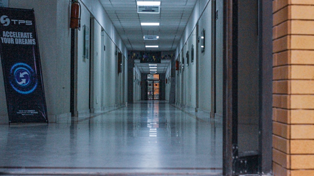 a long hallway with a sign on the side of it