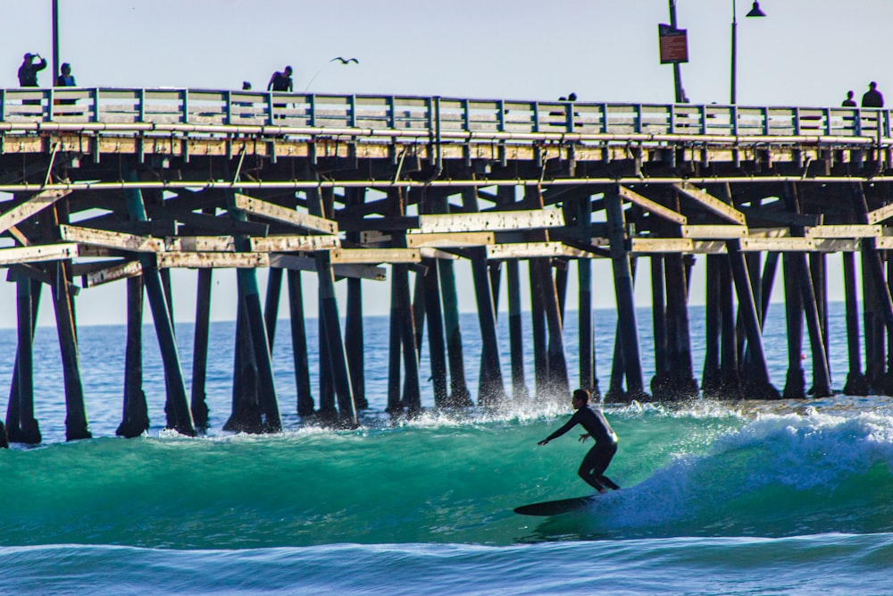 a group of people riding on the back of a pier