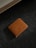 An elegant leather wallet displayed on a wooden table with natural lighting.