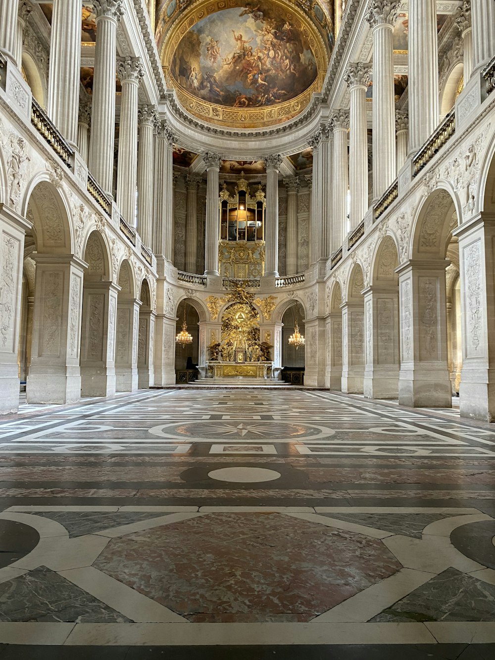 a large room with a painting on the ceiling