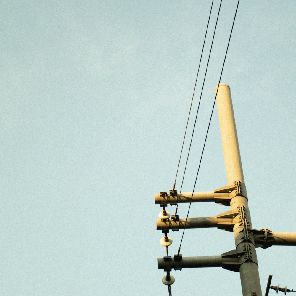 a telephone pole with wires attached to it