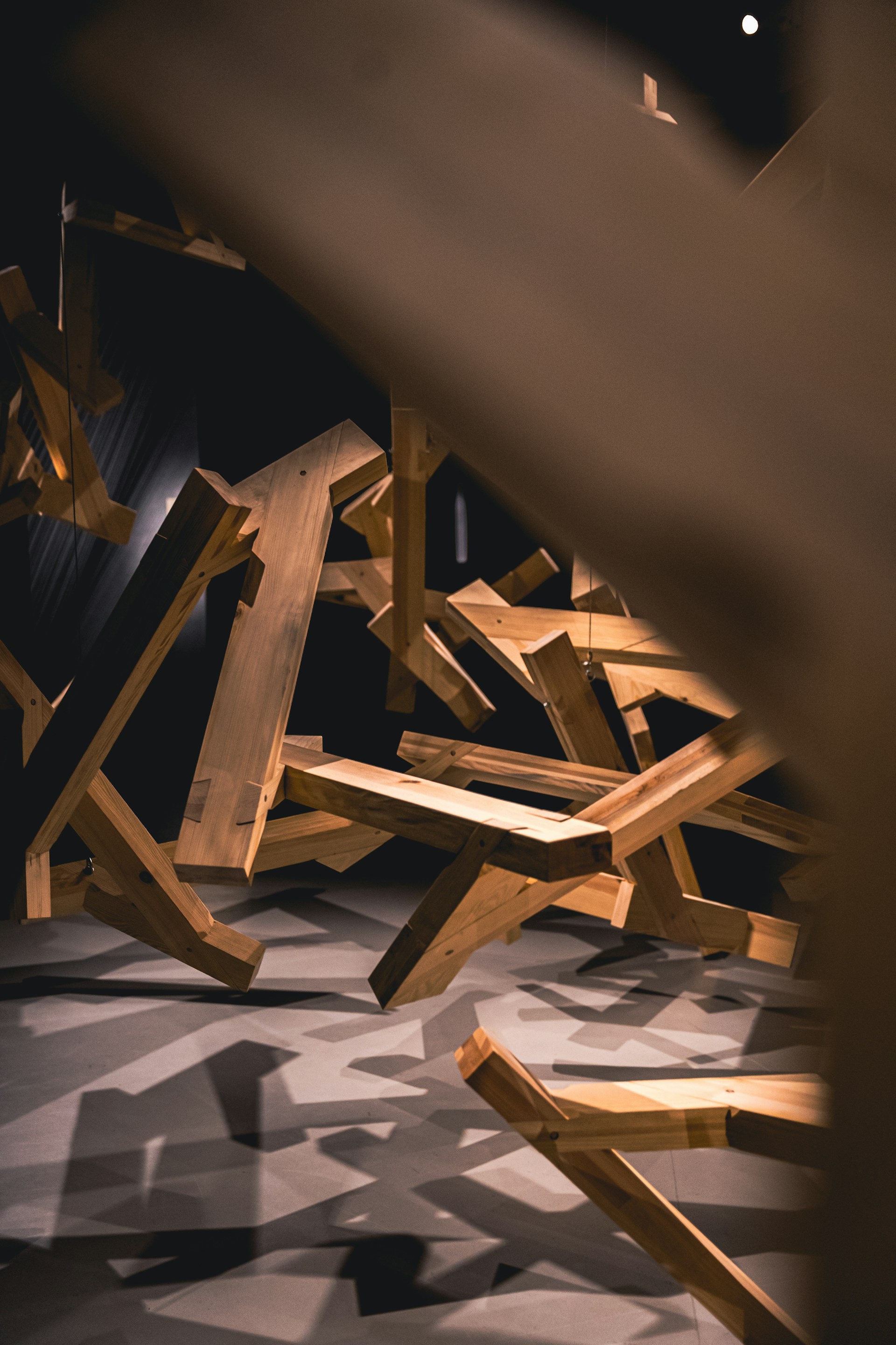 a pile of wooden pieces of furniture in a room
