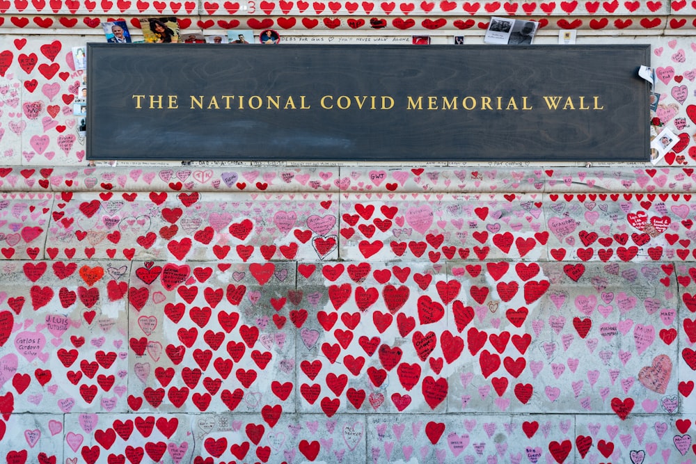 a memorial wall with hearts on it
