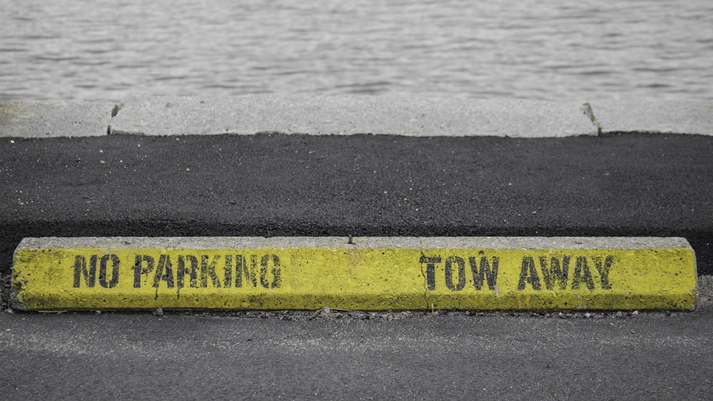 a no parking tow away sign on the side of the road