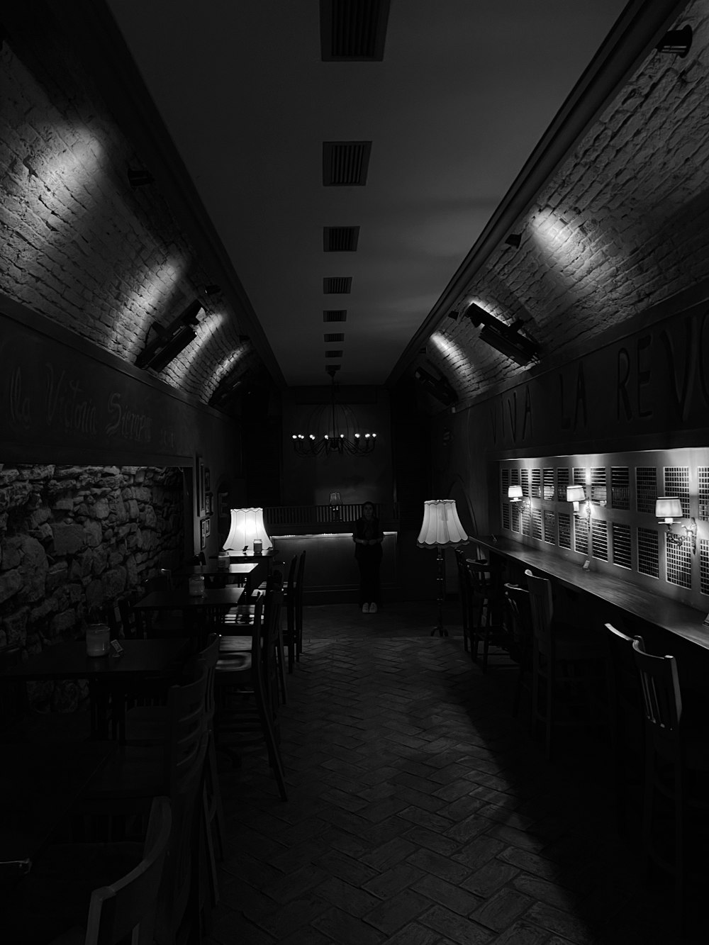 a dimly lit room with tables and chairs