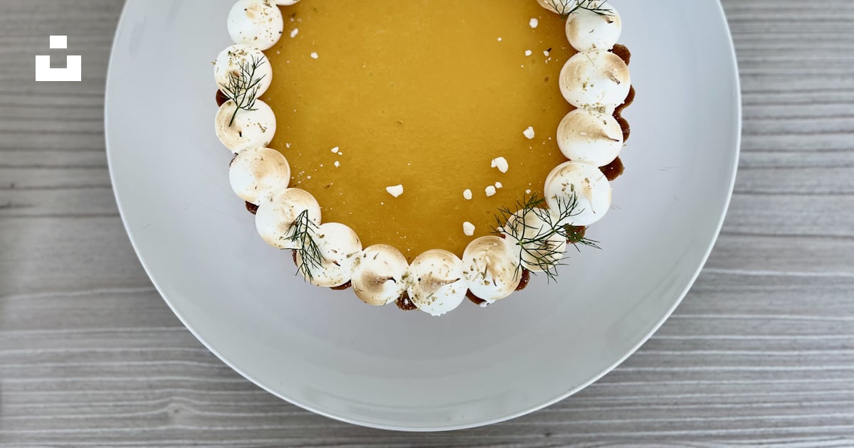 A white plate topped with a dessert covered in whipped cream photo