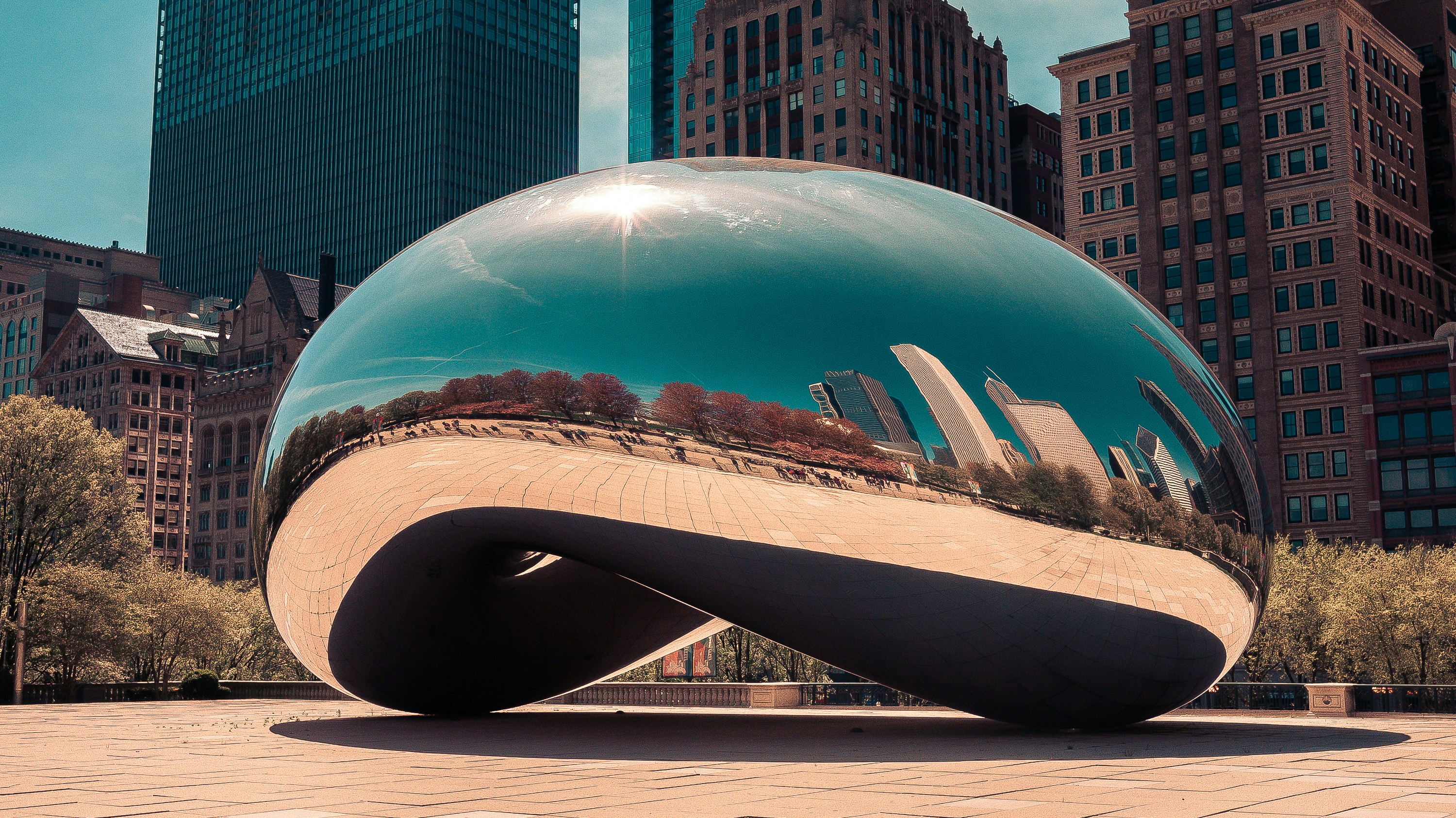 a large metal ball sitting on top of a sidewalk
