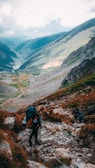 Group of friends hiking a scenic mountain trail with panoramic views