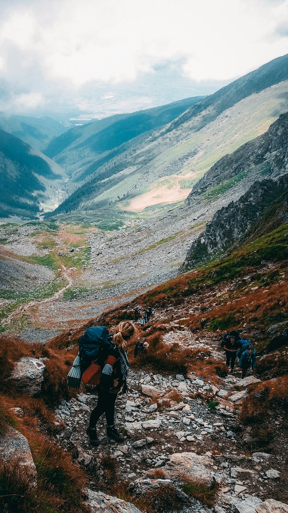 a group of people hiking up a mountain