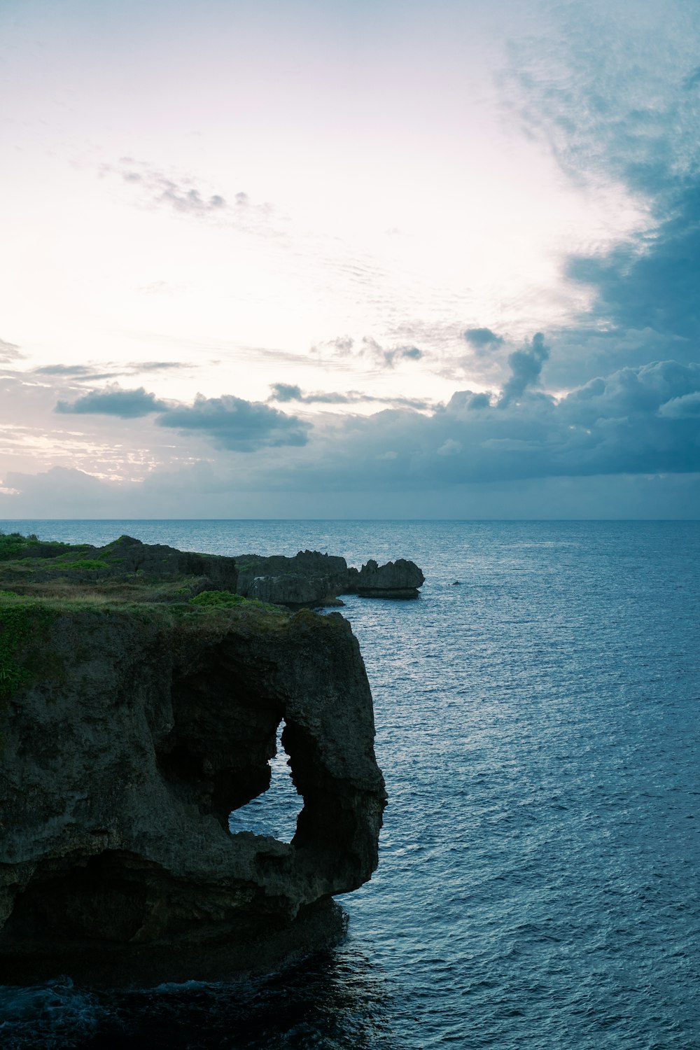 a large rock formation in the middle of the ocean