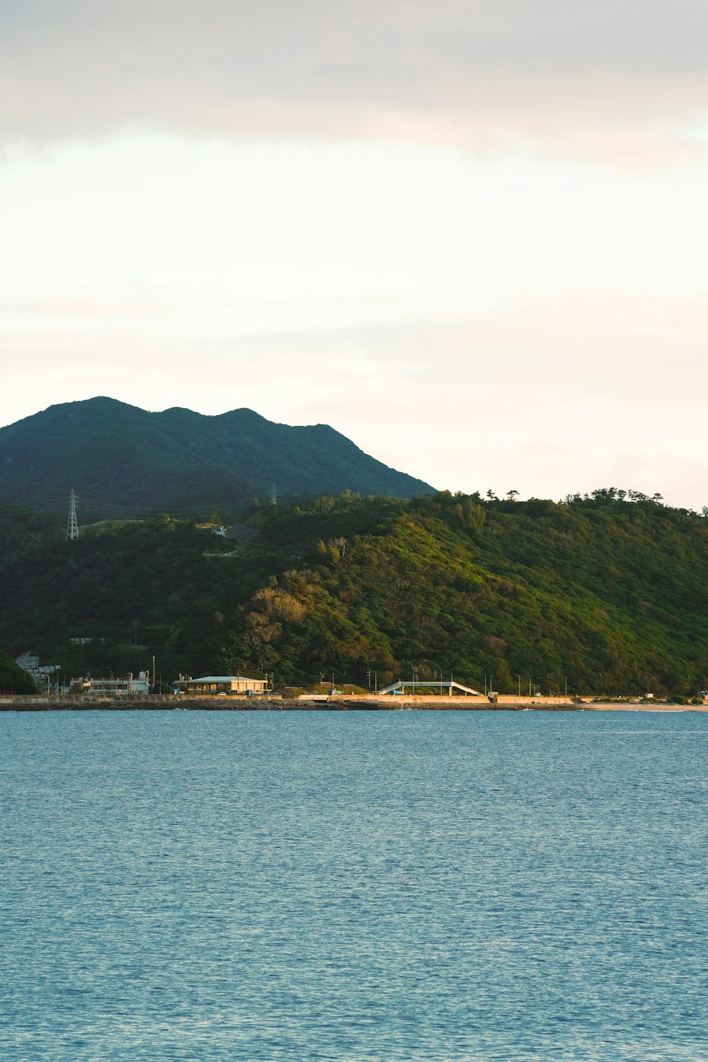 a large body of water with a mountain in the background