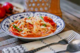 A clean kitchen setting with a salad tossed lightly with velora’s dressing, ready to serve.