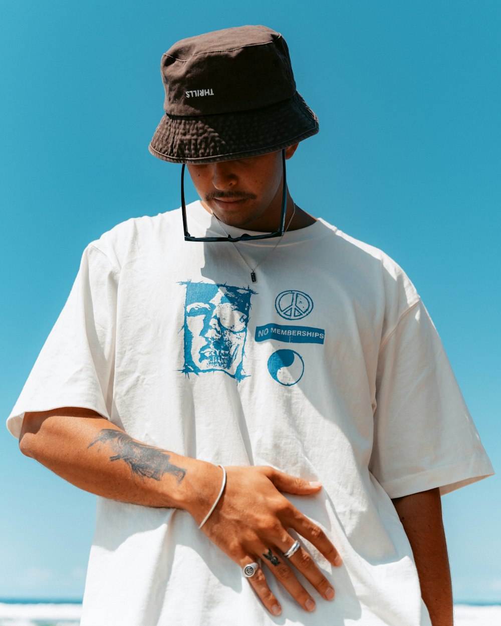 a man wearing a brown hat and a white shirt