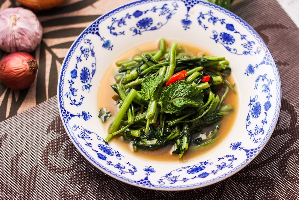 a bowl of broccoli and other vegetables on a table