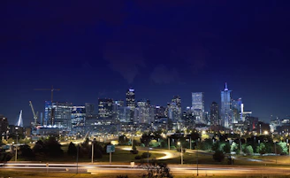 Smart cityscape blending green spaces with advanced digital infrastructure at dusk.