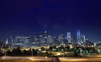 Smart cityscape blending green spaces with advanced digital infrastructure at dusk.