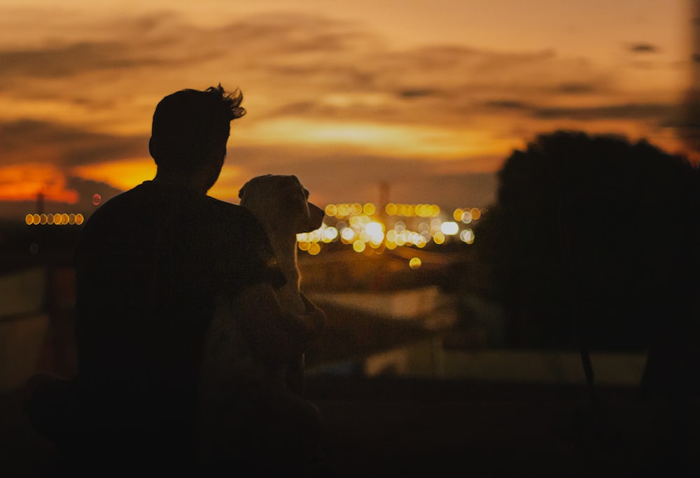 a couple of people that are standing in the dark