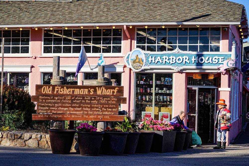 a pink building with a sign that says old fisherman's wharf