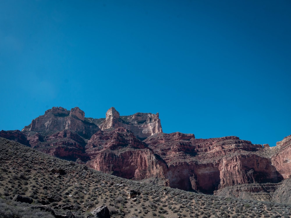 a view of a mountain range with a blue sky in the background