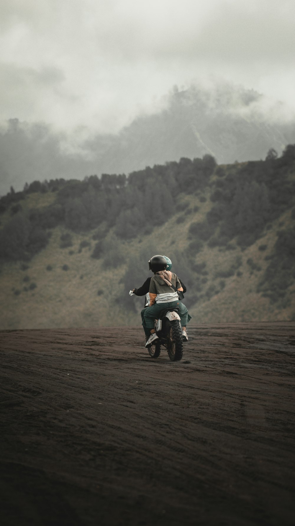 a person riding a motorcycle on a dirt road